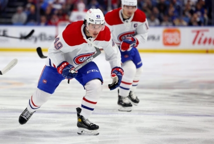Mar 27, 2023; Buffalo, New York, USA;  Montreal Canadiens left wing Rafael Harvey-Pinard (49) skates for a loose puck during the first period against the Buffalo Sabres at KeyBank Center. Mandatory Credit: Timothy T. Ludwig-USA TODAY Sports